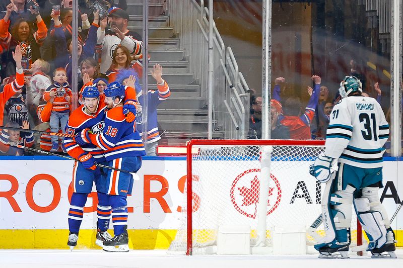 Apr 15, 2024; Edmonton, Alberta, CAN; The Edmonton Oilers celebrate a goal scored by forward Zach Hyman (18), during the second period against the San Jose Sharks at Rogers Place. The goal was assisted by forward Connor McDavid (97), his 100th of the season making him only the fourth player in NHL history history to record 100 assists in a single season. Mandatory Credit: Perry Nelson-USA TODAY Sports