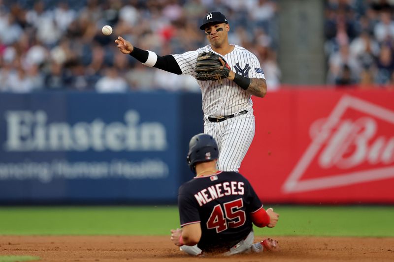 Aug 22, 2023; Bronx, New York, USA; New York Yankees second baseman Gleyber Torres (25) forces out Washington Nationals first baseman Joey Meneses (45) at second base and throws to first to complete a double play on a ball hit by Nationals designated hitter Keibert Ruiz (not pictured) during the first inning at Yankee Stadium. Mandatory Credit: Brad Penner-USA TODAY Sports