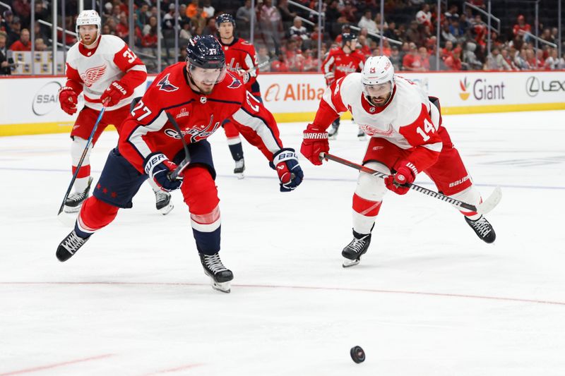 Sep 28, 2023; Washington, District of Columbia, USA; Washington Capitals defenseman Alexander Alexeyev (27) and Detroit Red Wings center Robby Fabbri (14) chase the puck in the third period at Capital One Arena. Mandatory Credit: Geoff Burke-USA TODAY Sports