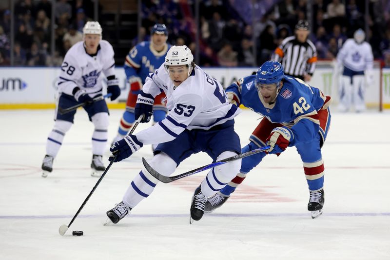 Mar 5, 2026; New York, New York, USA; Toronto Maple Leafs right wing Easton Cowan (53) controls the puck against New York Rangers center Noah Laba (42) during the first period at Madison Square Garden. Mandatory Credit: Brad Penner-Imagn Images