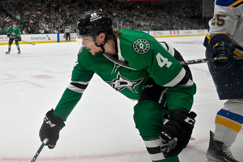 Dec 14, 2024; Dallas, Texas, USA; Dallas Stars defenseman Miro Heiskanen (4) is hit by the stick of St. Louis Blues center Jordan Kyrou (25) during the first period at American Airlines Center. Mandatory Credit: Jerome Miron-Imagn Images