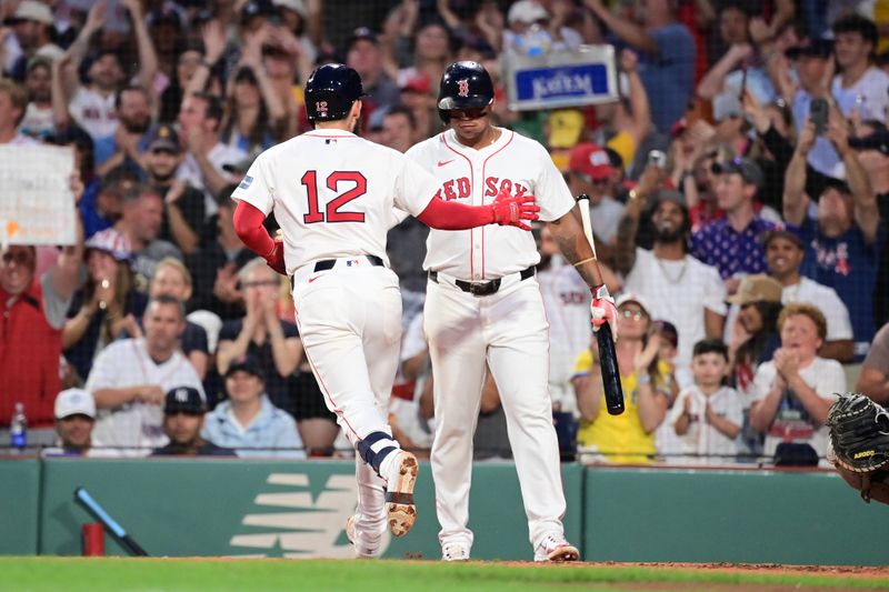 Jul 28, 2024; Boston, Massachusetts, USA; Boston Red Sox catcher Connor Wong (12) celebrates hitting a home run with third baseman Rafael Devers (11) during the fourth inning against the New York Yankees  at Fenway Park. Mandatory Credit: Eric Canha-USA TODAY Sports