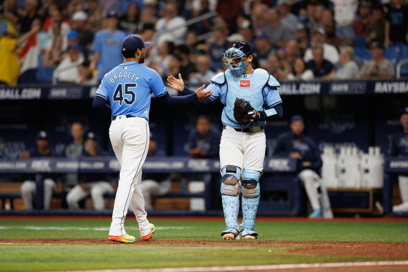 Jun 30, 2024; St. Petersburg, Florida, USA;  Tampa Bay Rays pitcher Taj Bradley (45) and catcher Alex Jackson (28) after pitching the fifth inning against the Washington Nationals at Tropicana Field. Mandatory Credit: Nathan Ray Seebeck-USA TODAY Sports