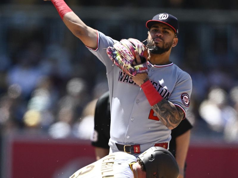 Jun 25, 2025; San Diego, California, USA; Washington Nationals second baseman Luis Garcia Jr. (2) throws over San Diego Padres center fielder Jackson Merrill (3) as he tries to turn a double play during the eighth inning at Petco Park. Mandatory Credit: Denis Poroy-Imagn Images