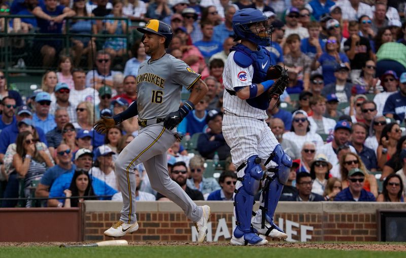 Jul 24, 2024; Chicago, Illinois, USA; Milwaukee Brewers outfielder Blake Perkins (16) scores the go ahead run against Chicago Cubs catcher Tomas Nido (6) during the ninth inning at Wrigley Field. Mandatory Credit: David Banks-USA TODAY Sports