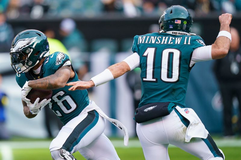 Philadelphia Eagles running back Miles Sanders (26) takes the hand off from quarterback Gardner Minshew (10) during the NFL football game against the New Orleans Saints, Sunday, Jan. 1, 2023, in Philadelphia. (AP Photo/Chris Szagola)