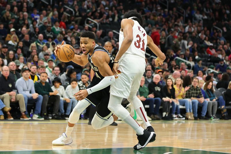 MILWAUKEE, WISCONSIN - JANUARY 26: Giannis Antetokounmpo #34 of the Milwaukee Bucks drives around Jarrett Allen #31 of the Cleveland Cavaliers during the first half of a game at Fiserv Forum on January 26, 2024 in Milwaukee, Wisconsin. NOTE TO USER: User expressly acknowledges and agrees that, by downloading and or using this photograph, User is consenting to the terms and conditions of the Getty Images License Agreement. (Photo by Stacy Revere/Getty Images)