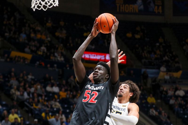 Jan 6, 2026; Morgantown, West Virginia, USA; Cincinnati Bearcats center Moustapha Thiam (52) shoots in the lane against the West Virginia Mountaineers during the first half at Hope Coliseum. Mandatory Credit: Ben Queen-Imagn Images