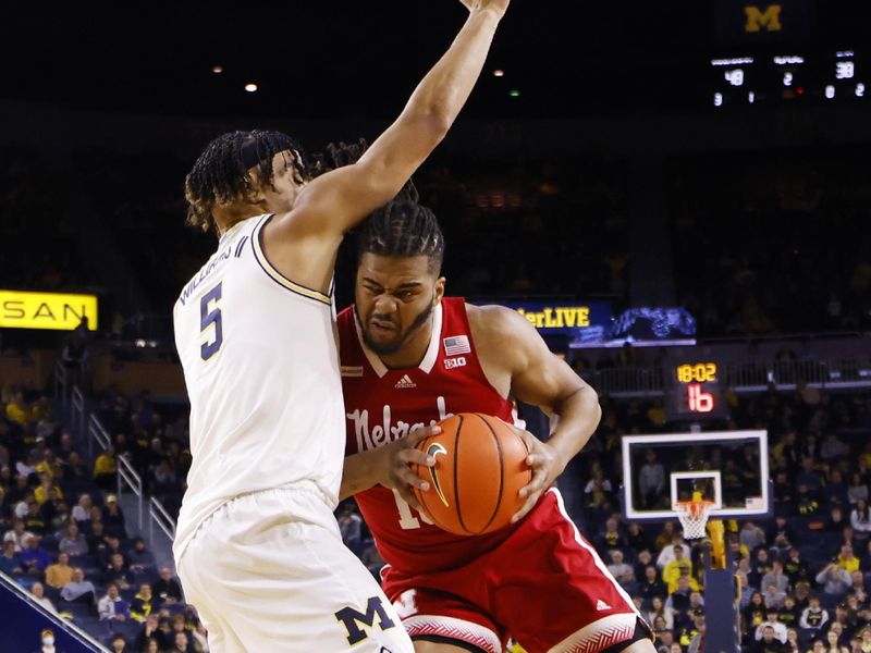 Feb 8, 2023; Ann Arbor, Michigan, USA;  Nebraska Cornhuskers forward Derrick Walker (13) is defended by Michigan Wolverines forward Terrance Williams II (5) in the first half at Crisler Center. Mandatory Credit: Rick Osentoski-USA TODAY Sports