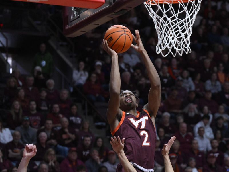 Feb 4, 2023; Blacksburg, Virginia, USA;  Virginia Tech Hokies guard Michael Collins Jr. (2) drives to basket over Virginia Cavaliers guard Kihei Clark (0) at Cassell Coliseum. Mandatory Credit: Lee Luther Jr.-USA TODAY Sports