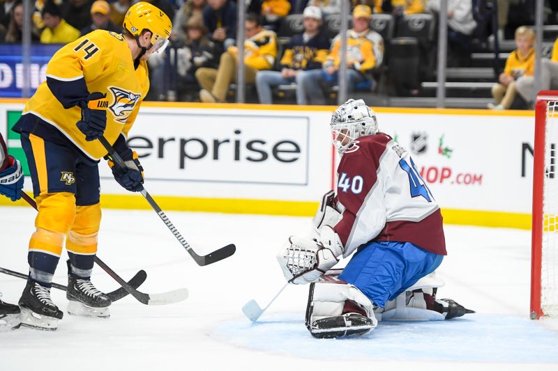 Nov 20, 2023; Nashville, Tennessee, USA;  Colorado Avalanche goaltender Alexandar Georgiev (40) blocks the shot of Nashville Predators left wing Gustav Nyquist (14)  during the first period at Bridgestone Arena. Mandatory Credit: Steve Roberts-USA TODAY Sports