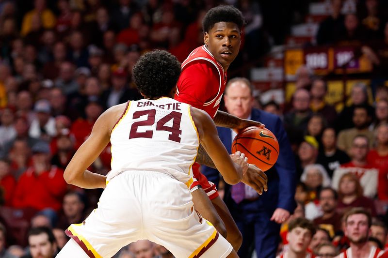 Jan 23, 2024; Minneapolis, Minnesota, USA; Wisconsin Badgers guard AJ Storr (2) dribbles as Minnesota Golden Gophers guard Cam Christie (24) defends during the second half at Williams Arena. Mandatory Credit: Matt Krohn-USA TODAY Sports