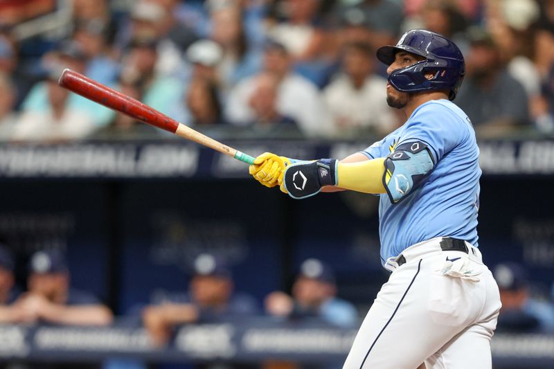 Jul 9, 2023; St. Petersburg, Florida, USA;  Tampa Bay Rays third baseman Isaac Paredes (17) hits a two-run home run against the Atlanta Braves in the first inning at Tropicana Field. Mandatory Credit: Nathan Ray Seebeck-USA TODAY Sports