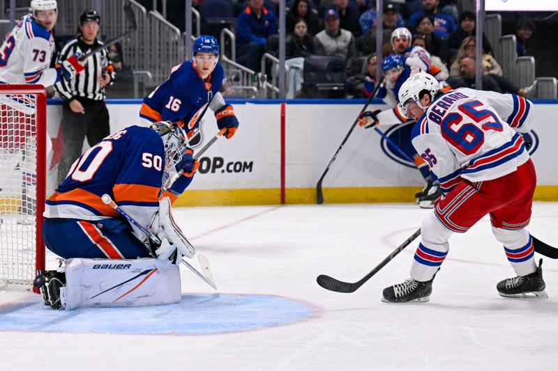 Apr 10, 2025; Elmont, New York, USA;  New York Rangers left wing Brett Berard (65) scores a goal on New York Islanders goaltender Marcus Hogberg (50) during the third period at UBS Arena. Mandatory Credit: Dennis Schneidler-Imagn Images