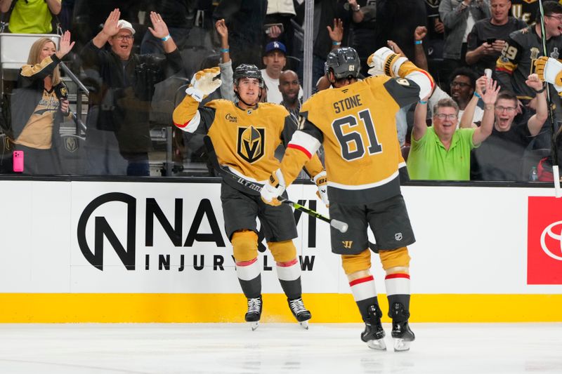 Oct 9, 2024; Las Vegas, Nevada, USA; Vegas Golden Knights defenseman Zach Whitecloud (2) celebrates with right wing Mark Stone (61) after scoring a goal against the Colorado Avalanche during the second period at T-Mobile Arena. Mandatory Credit: Lucas Peltier-Imagn Images