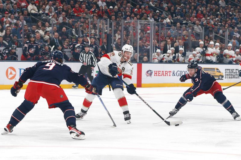 Mar 5, 2026; Columbus, Ohio, USA; Florida Panthers left wing Matthew Tkachuk (19) passes the puck as Columbus Blue Jackets center Charlie Coyle (3) trails the play during the first period at Nationwide Arena. Mandatory Credit: Russell LaBounty-Imagn Images
