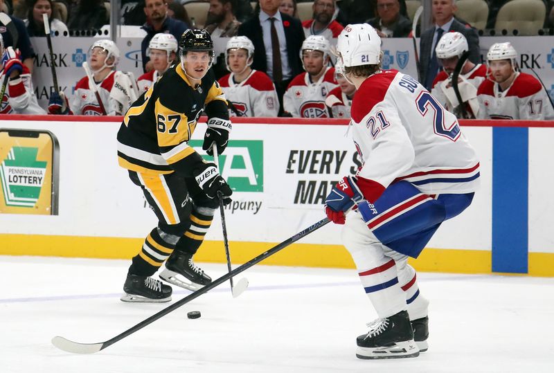 Nov 2, 2024; Pittsburgh, Pennsylvania, USA;  Pittsburgh Penguins right wing Rickard Rakell (67) skates with the puck against Montreal Canadiens defenseman Kaiden Guhle (21) during the third period at PPG Paints Arena. Mandatory Credit: Charles LeClaire-Imagn Images