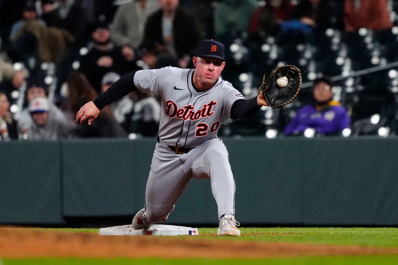 May 7, 2025; Denver, Colorado, USA; Detroit Tigers first base Spencer Torkelson (20) fields the ball in the tenth inning against the Colorado Rockies at Coors Field. Mandatory Credit: Ron Chenoy-Imagn Images