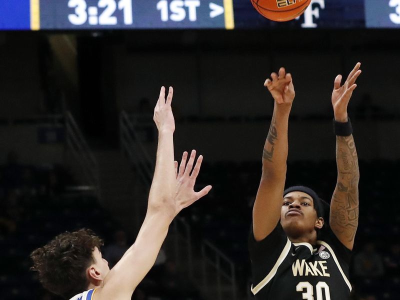 Jan 25, 2023; Pittsburgh, Pennsylvania, USA;  Wake Forest Demon Deacons guard Damari Monsanto (30) shoots a three point basket against Pittsburgh Panthers forward Jorge Diaz Graham (31) during the first half at the Petersen Events Center. Mandatory Credit: Charles LeClaire-USA TODAY Sports