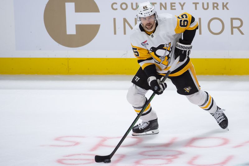 Mar 12, 2024; Ottawa, Ontario, CAN; Pittsburgh Penguins defenseman Erik Karlsson (65) skates with the puck iin the third period against the  Ottawa Senators at the Canadian Tire Centre. Mandatory Credit: Marc DesRosiers-USA TODAY Sports