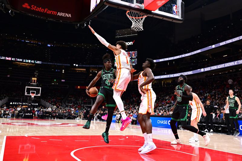 ATLANTA, GA - NOVEMBER 4: Jrue Holiday #4 of the Boston Celtics passes the ball during the game against the Atlanta Hawks on November 4, 2024 at State Farm Arena in Atlanta, Georgia.  NOTE TO USER: User expressly acknowledges and agrees that, by downloading and/or using this Photograph, user is consenting to the terms and conditions of the Getty Images License Agreement. Mandatory Copyright Notice: Copyright 2024 NBAE (Photo by Adam Hagy/NBAE via Getty Images)