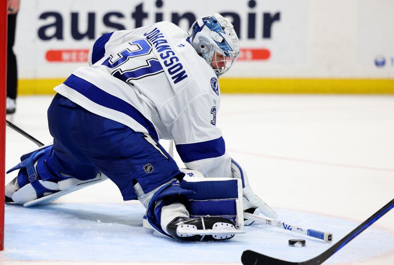 Apr 5, 2025; Buffalo, New York, USA;  Tampa Bay Lightning goaltender Jonas Johansson (31) makes a save in overtime against the Buffalo Sabres at KeyBank Center. Mandatory Credit: Timothy T. Ludwig-Imagn Images