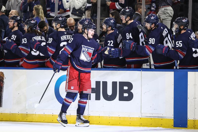 Oct 24, 2024; New York, New York, USA;  New York Rangers left wing Alexis Lafrenière (13) celebrates with his teammates after scoring a goal in the first period against the Florida Panthers at Madison Square Garden. Mandatory Credit: Wendell Cruz-Imagn Images