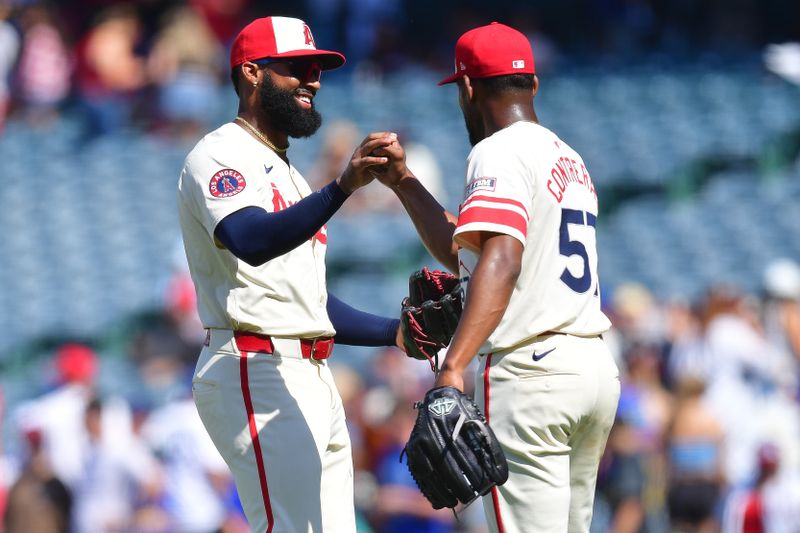 Jul 14, 2024; Anaheim, California, USA; Los Angeles Angels right fielder Jo Adell (7) and pitcher Roansy Contreras (57) celebrate the victory against the Seattle Mariners at Angel Stadium. Mandatory Credit: Gary A. Vasquez-USA TODAY Sports