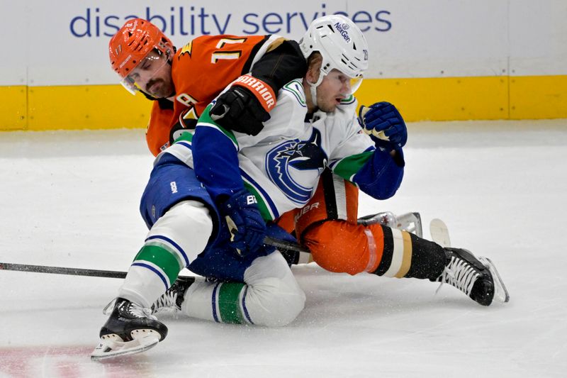 Nov 5, 2024; Anaheim, California, USA;  Vancouver Canucks defenseman Erik Brannstrom (26) and Anaheim Ducks left wing Alex Killorn (17) battle on the ice in the second period at Honda Center. Mandatory Credit: Jayne Kamin-Oncea-Imagn Images