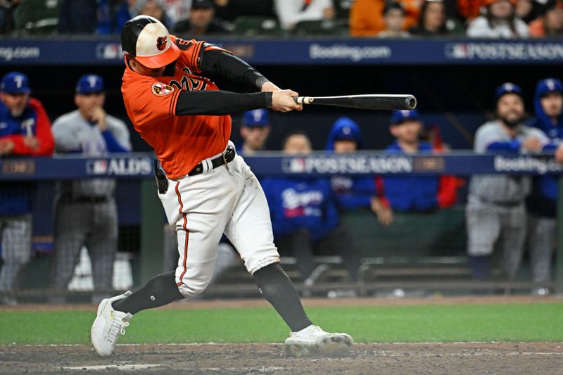 Oct 8, 2023; Baltimore, Maryland, USA; Baltimore Orioles left fielder Austin Hays (21) hits a single during the ninth inning against the Texas Rangers during game two of the ALDS for the 2023 MLB playoffs at Oriole Park at Camden Yards. Mandatory Credit: Tommy Gilligan-USA TODAY Sports