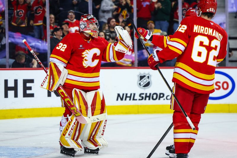 Nov 15, 2024; Calgary, Alberta, CAN; Calgary Flames goaltender Dustin Wolf (32) celebrate win with teammates after defeating Nashville Predators at Scotiabank Saddledome. Mandatory Credit: Sergei Belski-Imagn Images