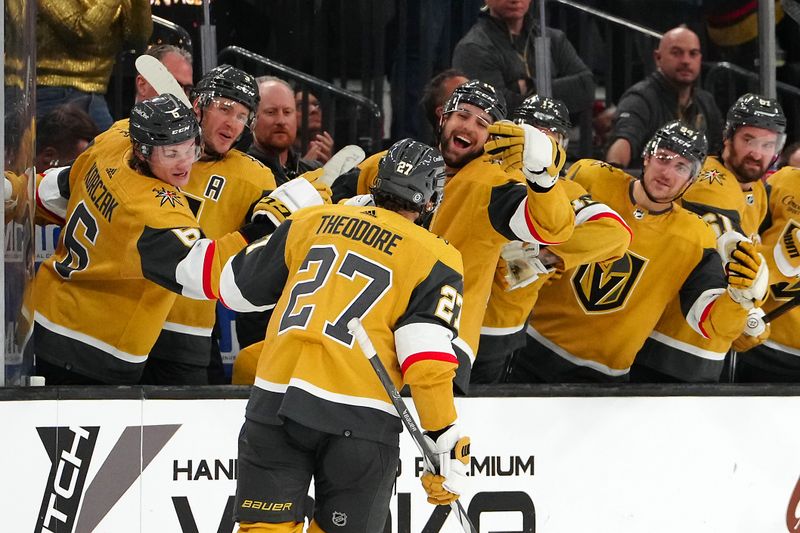 Oct 17, 2023; Las Vegas, Nevada, USA; Vegas Golden Knights defenseman Shea Theodore (27) celebrates after scoring a goal against the Dallas Stars during a shootout at T-Mobile Arena. Mandatory Credit: Stephen R. Sylvanie-USA TODAY Sports