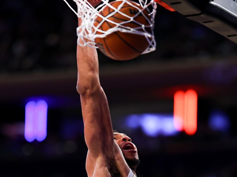 NEW YORK, NEW YORK - DECEMBER 25: Giannis Antetokounmpo #34 of the Milwaukee Bucks dunks during the third quarter against the New York Knicks at Madison Square Garden on December 25, 2023 in New York City.  NOTE TO USER: User expressly acknowledges and agrees that, by downloading and or using this photograph, User is consenting to the terms and conditions of the Getty Images License Agreement. (Photo by Rich Graessle/Getty Images)