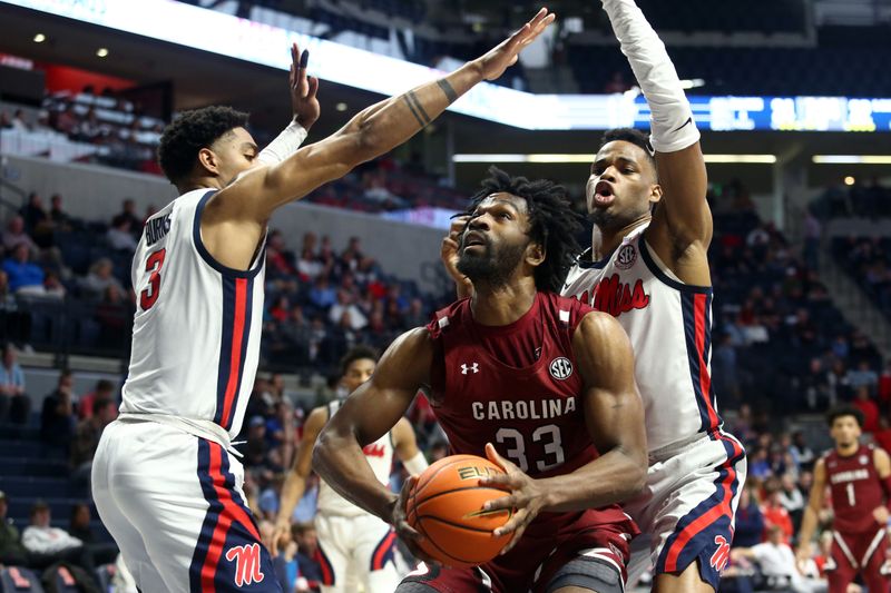 Feb 11, 2023; Oxford, Mississippi, USA; South Carolina Gamecocks forward Josh Gray (33) shoots as Mississippi Rebels forward Myles Burns (3) and forward Theo Akwuba (10) defend during the first half at The Sandy and John Black Pavilion at Ole Miss. Mandatory Credit: Petre Thomas-USA TODAY Sports