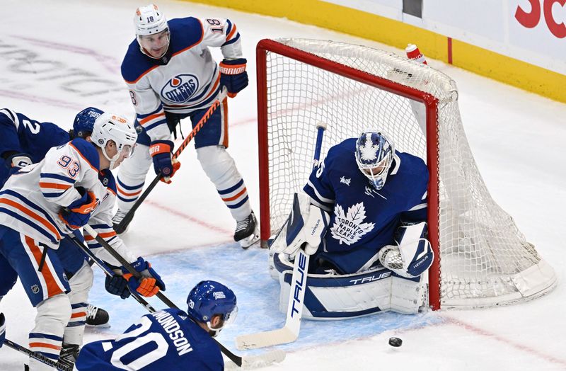 Mar 23, 2024; Toronto, Ontario, CAN; Toronto Maple Leafs goalie Ilya Samsonov (35) makes a save as Edmonton Oilers forwards Ryan Nugent-Hopkins (93) and Zach Hyman (18) watch for a rebound in the third period at Scotiabank Arena. Mandatory Credit: Dan Hamilton-USA TODAY Sports