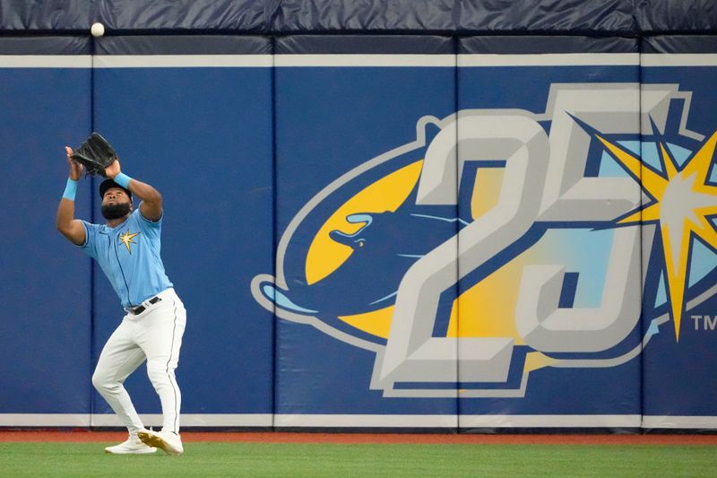 Apr 2, 2023; St. Petersburg, Florida, USA; Tampa Bay Rays right fielder Manuel Margot (13) catches a ball hit by Detroit Tigers center fielder Riley Greene (31) during the first inning at Tropicana Field. Mandatory Credit: Dave Nelson-USA TODAY Sports