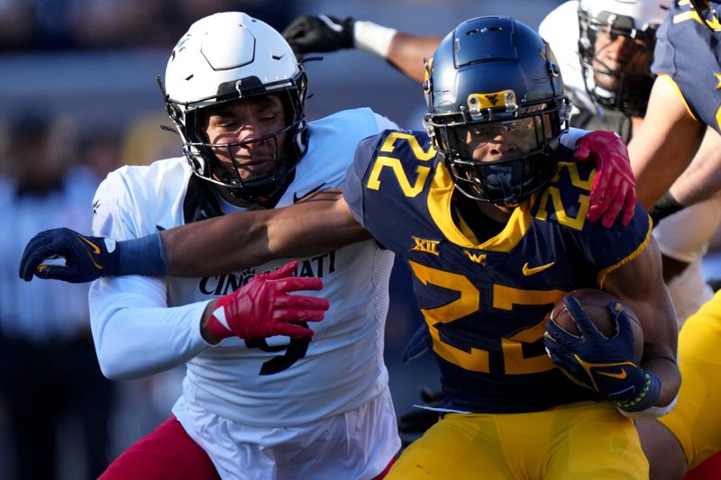 Nov 18, 2023; Morgantown, West Virginia, USA; Cincinnati Bearcats linebacker Daniel Grzesiak (9) tackles West Virginia Mountaineers running back Jahiem White (22) in the first quarter at Milan Puskar Stadium.  Mandatory Credit: Kareem Elgazzar-USA TODAY Sports