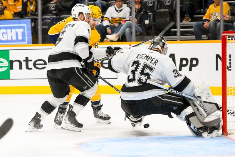 Nov 4, 2024; Nashville, Tennessee, USA;  Los Angeles Kings goaltender Darcy Kuemper (35) blocks the shot of Nashville Predators center Tommy Novak (82) during the first period at Bridgestone Arena. Mandatory Credit: Steve Roberts-Imagn Images