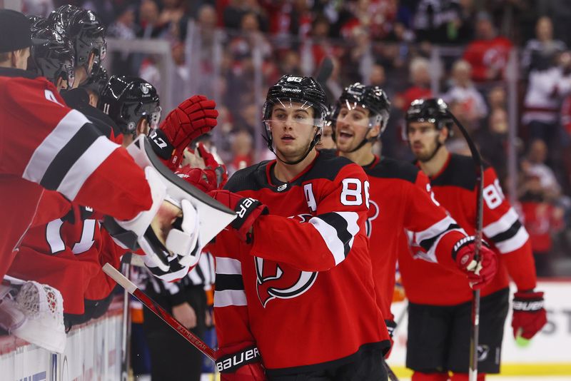 Nov 28, 2023; Newark, New Jersey, USA; New Jersey Devils center Jack Hughes (86) celebrates his goal against the New York Islanders during the third period at Prudential Center. Mandatory Credit: Ed Mulholland-USA TODAY Sports