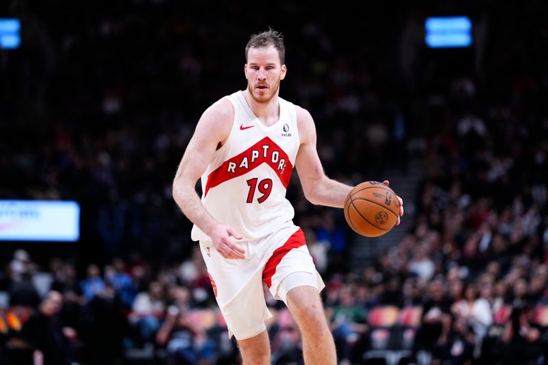 TORONTO, ON - JANUARY 6: Jakob Poeltl #19 of the Toronto Raptors moves the ball against the Milwaukee Bucks at the Scotiabank Arena on January 6, 2025 in Toronto, Ontario, Canada. NOTE TO USER: User expressly acknowledges and agrees that, by downloading and/or using this Photograph, user is consenting to the terms and conditions of the Getty Images License Agreement. (Photo by Kevin Sousa/Getty Images)