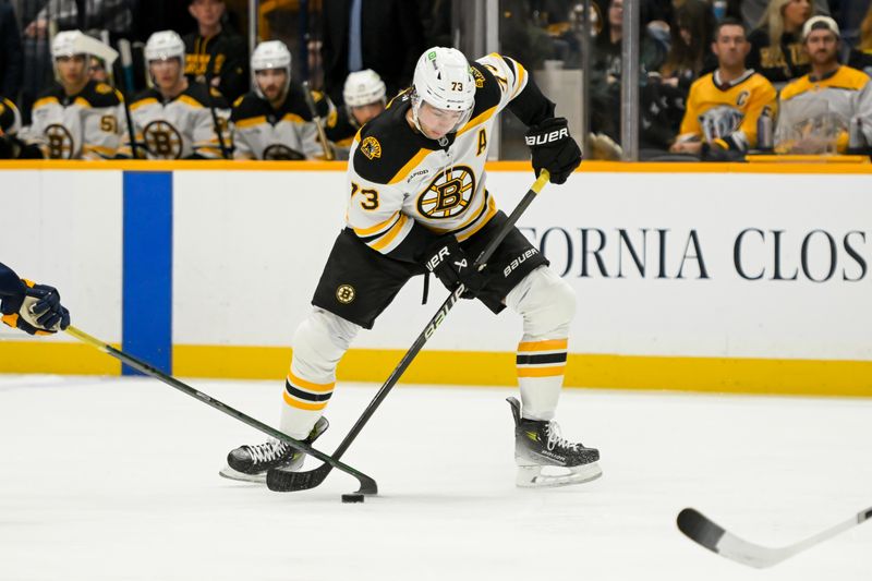 Oct 22, 2024; Nashville, Tennessee, USA; Boston Bruins defenseman Charlie McAvoy (73) takes a shot against the Nashville Predators during the second period at Bridgestone Arena. Mandatory Credit: Steve Roberts-Imagn Images