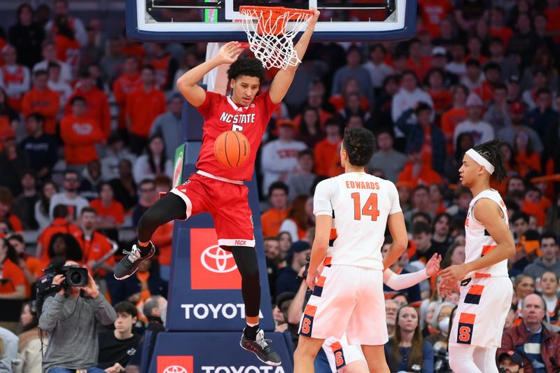 Feb 14, 2023; Syracuse, New York, USA; North Carolina State Wolfpack guard Jack Clark (5) dunks the ball as Syracuse Orange center Jesse Edwards (14) defends during the first half at the JMA Wireless Dome. Mandatory Credit: Rich Barnes-USA TODAY Sports