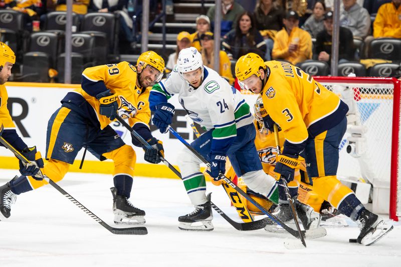 May 3, 2024; Nashville, Tennessee, USA; Nashville Predators defenseman Jeremy Lauzon (3) blocks the shot of Vancouver Canucks center Pius Suter (24) during the second period in game six of the first round of the 2024 Stanley Cup Playoffs at Bridgestone Arena. Mandatory Credit: Steve Roberts-USA TODAY Sports