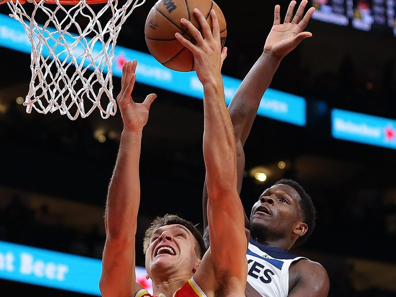 ATLANTA, GEORGIA - OCTOBER 30:  Bogdan Bogdanovic #13 of the Atlanta Hawks drives against Anthony Edwards #5 of the Minnesota Timberwolves during the fourth quarter at State Farm Arena on October 30, 2023 in Atlanta, Georgia.  NOTE TO USER: User expressly acknowledges and agrees that, by downloading and/or using this photograph, user is consenting to the terms and conditions of the Getty Images License Agreement.  (Photo by Kevin C. Cox/Getty Images)