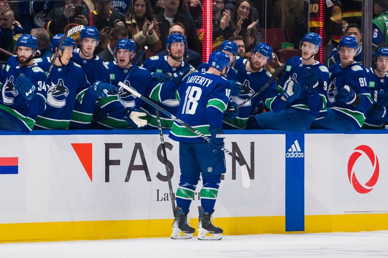 Dec 9, 2023; Vancouver, British Columbia, CAN; Vancouver Canucks forward Sam Lafferty (18) celebrates his goal against the Carolina Hurricanes in the first period at Rogers Arena. Mandatory Credit: Bob Frid-USA TODAY Sports