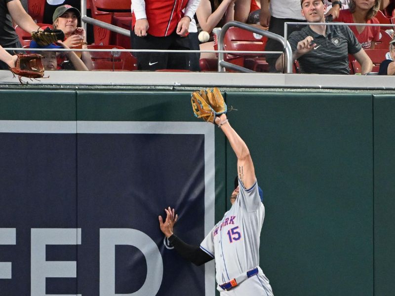 Jul 2, 2024; Washington, District of Columbia, USA; New York Mets right fielder Tyrone Taylor (15) leaps into the air to catch a fly ball against the Washington Nationals during the seventh inning at Nationals Park. Mandatory Credit: Rafael Suanes-USA TODAY Sports