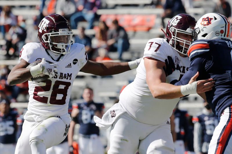 Dec 5, 2020; Auburn, Alabama, USA;  Texas A&M Aggies running back Isaiah Spiller (28) gets help from his offensive line during the first quarter against the Auburn Tigers at Jordan-Hare Stadium. Mandatory Credit: John Reed-USA TODAY Sports