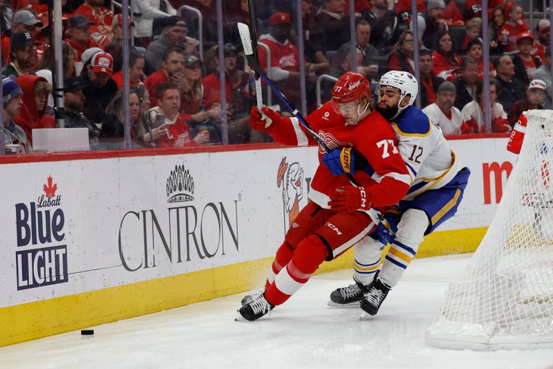 Apr 7, 2024; Detroit, Michigan, USA; Detroit Red Wings defenseman Simon Edvinsson (77) and Buffalo Sabres left wing Jordan Greenway (12) fight for position in the third period at Little Caesars Arena. Mandatory Credit: Rick Osentoski-USA TODAY Sports