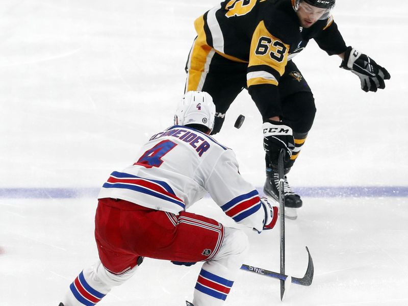 Nov 22, 2023; Pittsburgh, Pennsylvania, USA; Pittsburgh Penguins left wing Radim Zohorna (63) and New York Rangers defenseman Braden Schneider (4) battle for the puck during the third period at PPG Paints Arena. The Rangers won 1-0. Mandatory Credit: Charles LeClaire-USA TODAY Sports