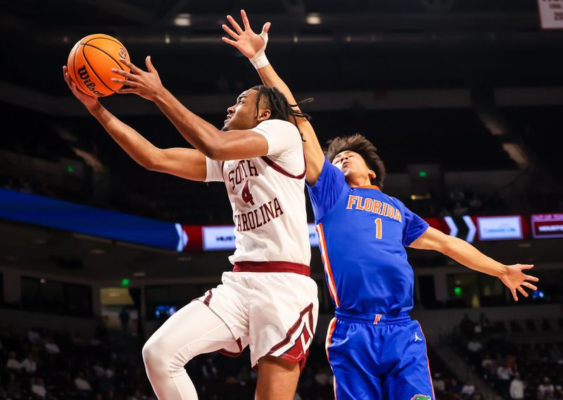 Jan 28, 2026; Columbia, South Carolina, USA; South Carolina Gamecocks guard Kobe Knox (4) drives past Florida Gators guard Xaivian Lee (1) in the first half at Colonial Life Arena. Mandatory Credit: Jeff Blake-Imagn Images